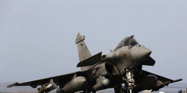 A French navy Rafale fighter jet lands on the aircraft carrier Charles de Gaulle operating in the Gulf on February 25, 2015. A dozen French fighter jets are catapulted into the sky from the aircraft carrier in the Gulf, roaring off towards Iraq as part of the campaign against the Islamic State (IS) jihadist group. AFP PHOTO / PATRICK BAZ (Photo credit should read PATRICK BAZ/AFP/Getty Images)