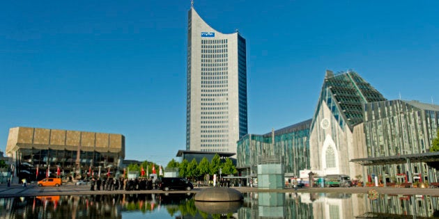 The socalled MDR building (C), the main campus building of the University of Leipzig (R) and the Gewandhaus concert hall (L) at Augustus Platz reflect on water in Leipzig, eastern Germany, is pictured on May 23, 2013. AFP PHOTO / ROBERT MICHAEL (Photo credit should read ROBERT MICHAEL/AFP/Getty Images)