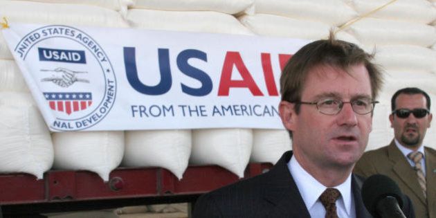 Amman, JORDAN: US ambassador to Jordan David Hale speaks to reporters in front of bags of wheat in Amman 31 August 2006 before they are sent to Lebanon. The US government today donated 700 tonnes of wheat to Lebanon as part of a 'goodwill' gesture to help relief efforts, with the first trucks heading for Beirut from Jordan, the US embassy said. The wheat, which was milled into flower at Jordan's South Amman Mills, is expected to help feed 350,000 people in Lebanon, Hale said. Six trucks were heading to Lebanon, via Syria, today while 12 others will follow in the next couple of days, the embassy said. AFP PHOTO/KHALIL MAZRAAWI (Photo credit should read KHALIL MAZRAAWI/AFP/Getty Images)