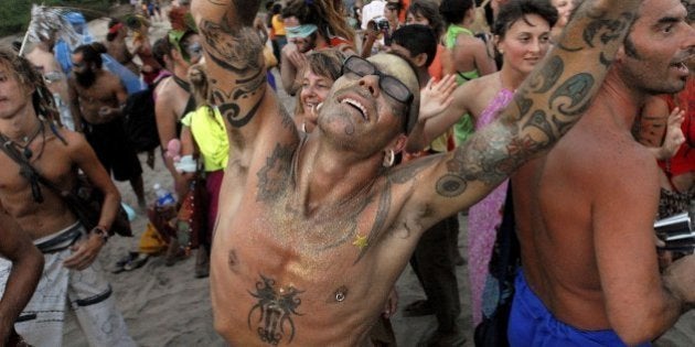 GOA, INDIA - FEBRUARY 27: Young travellers party on a beach, Febraury 27, 2006 in the Indian resort of Goa. The tiny Indian state became known as a hippie heaven in the 1960's and its beaches have hosted all night parties for adventurous backpacking tourists ever since. (Photo by Ami Vitale/Getty Images)