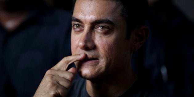 Bollywood actor Aamir Khan gestures during a media interaction on completion of his 25 years in Indian cinema, in Mumbai, India, Monday, April 29, 2013. (AP Photo/Rafiq Maqbool)