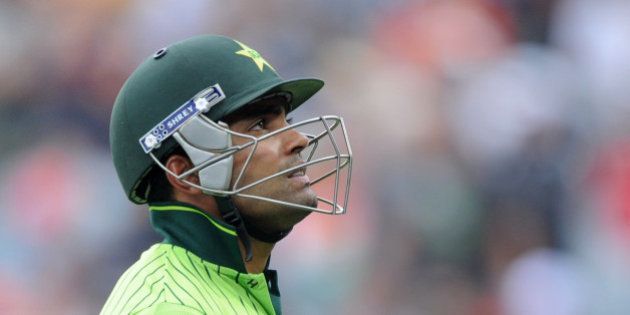 Pakistan's Umar Akmal walks from the field after he was dismissed for 13 runs during their Cricket World Cup Pool B match against South Africa in Auckland, New Zealand, Saturday, March 7, 2015. (AP Photo/Ross Setford)