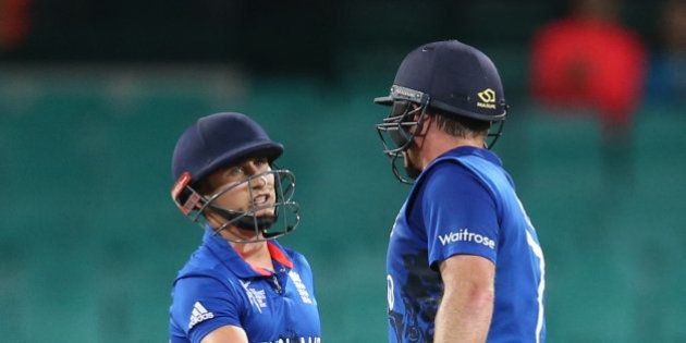 England's James Taylor, left, congratulates teammate Ian Bell for completing a half century during their Cricket World Cup pool A match against Afghanistan in Sydney, Australia, Friday, March 13, 2015. (AP Photo/Rick Rycroft)
