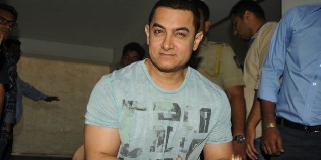 Indian Bollywood film actor, director, producer and television presenter Aamir Khan celebrates his 50th birthday the day before the event, at his home in Mumbai on March 13, 2015. AFP PHOTO (Photo credit should read STR/AFP/Getty Images)