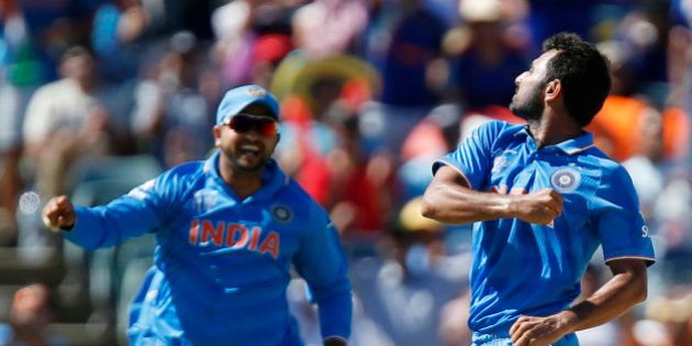 India's Mohammed Shami, right, celebrates with his teammate M S Dhoni after dismissing West Indies batsman Dwayne Smith during their Cricket World Cup Pool B match in Perth, Australia, Friday, March 6, 2015. (AP Photo Theron Kirkman)