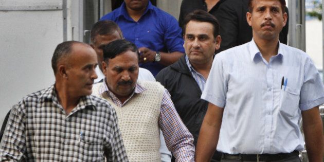 NEW DELHI, INDIA - MARCH 13: Two accused being taken to be produced in special CBI court in the leakage of confidential documents related to foreign investments in the finance and commerce ministries on March 13, 2015 in New Delhi, India. Three people, including two government officials were arrested yesterday in the leakage of confidential documents related to foreign investments in the finance and commerce ministries. (Photo by Arun Sharma/Hindustan Times via Getty Images)