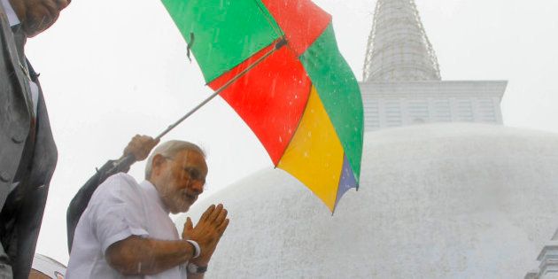 Indian Prime Minister Narendra Modi folds his hands in a sign of respect during his visit to Ruwanwelisaya, a sacred stupa in Anuradhapura, about 230 kilometers northeast of Colombo, Sri Lanka, Saturday, March 14, 2015. Modi said on Friday that India's neighbors should be the first beneficiaries of the nation's economic progress as he sought to woo smaller Indian Ocean states away from increasing Chinese influence. (AP Photo/Eranga Jayawardena)