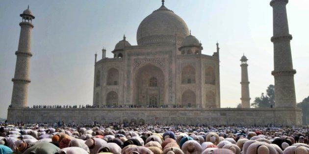 Indian Muslims offer prayers during Eid al-Adha, or the Feast of the Sacrifice, at the Taj Mahal monument in Agra, India, Monday, Oct. 6, 2014. (AP Photo/Pawan Sharma)