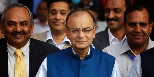 Indian Finance Minister Arun Jaitley holds a briefcase containing union budget for the year 2015-16 as he leaves his office for Parliament to present the union budget in New Delhi, India, Saturday, Feb. 28, 2015. (AP Photo/Altaf Qadri)