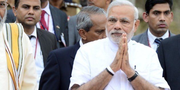Indian Prime Minister Narendra Modi (R) and the Sri Lankan chief minister of the northern province C. V. Vigneswaran (L) arrive for a ceremony to hand over Indian-funded houses to Tamils displaced or made destitute by fighting in Jaffna, some 400 kilometres (250 miles) north of Colombo on March 14, 2015. Narendra Modi landed in Jaffna on March 14, becoming the first Indian prime minister to visit Sri Lanka's war-ravaged northern Tamil heartland. AFP PHOTO / Lakruwan WANNIARACHCHI (Photo credit should read LAKRUWAN WANNIARACHCHI/AFP/Getty Images)