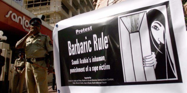 An Indian human rights activist holds banner as she protests against the punishment of a Saudi Arabian rape victim, outside the Saudi Arabian counsulate in Mumbai, 22 November 2007. The demonstrators gathered to protest against the sentencing of a Saudi rape victim to 200 lashes and six months in jail for 'being in the car of an unrelated male at the time of the rape. Saudi Arabia enforces a strict form of Sunni Islam known as Wahhabism and forbids unrelated men and women from associating with each other, bans women from driving and requires them to cover head-to-toe in public. AFP PHOTO/Pal PILLAI (Photo credit should read PAL PILLAI/AFP/Getty Images)