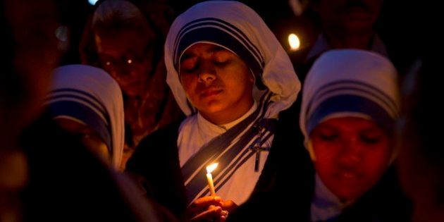 Christian nuns pray as they hold a candle light vigil to condemn the gang rape of a nun at a Christian missionary school in eastern India outside the Sacred Heart cathedral in New Delhi, India, Monday, March 16, 2015. According to police a nun in her 70s was gang-raped by a group of bandits when she tried to prevent them from committing a robbery in the Convent of Jesus and Mary School in West Bengal state's Nadia district. The attack early Saturday is the latest crime to focus attention on the scourge of sexual violence in India. (AP Photo/Saurabh Das)