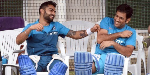 Indian cricket players Virat Kohli (L) and captain Mahendra Singh Dhoni (R) share a lighter moment during a training session ahead of their 2015 Cricket World Cup quarter-final match against Bangladesh in Melbourne on March 18, 2015. AFP PHOTO / William WEST --IMAGE RESTRICTED TO EDITORIAL USE - STRICTLY NO COMMERCIAL USE-- (Photo credit should read WILLIAM WEST/AFP/Getty Images)
