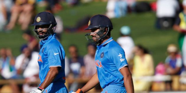 India's Shikhar Dhawan left, and Rohit Sharma walk onto the field to start the Indian batting attack during their Cricket World Cup Pool B match against the United Arab Emirates in Perth, Australia, Saturday, Feb 28, 2015. (AP Photo/Theron Kirkman)