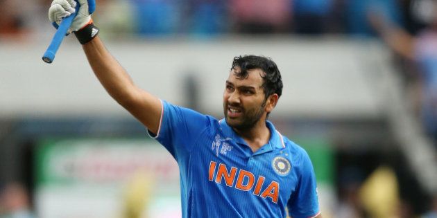 India's Rohit Sharma celebrates after scoring a century while batting against Bangladesh during their Cricket World Cup quarterfinal match in Melbourne, Australia, Thursday, March 19, 2015. (AP Photo/Rick Rycroft)
