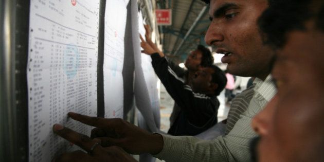 NEW DELHI, INDIA - 2015/02/27: Passengers are checking their name in a train reservation slip at New Delhi railway station on Thursday. Union Railways Minister Suresh Prabhu has presented Union Rail Budget 2015. There is 67% more fund for the passengers amenities and no change in passenger fares in Rail Budget 2015. (Photo by Anil Kumar Shakya/Pacific Press/LightRocket via Getty Images)
