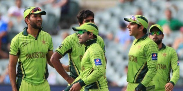 Pakistanâs Umar Akmal, center, celebrates with teammates after taking a catch to dismiss Irelandâs Stuart Thompson during their Cricket World Cup Pool B match in Adelaide, Australia, Sunday, March 15, 2015. (AP Photo/James Elsby)