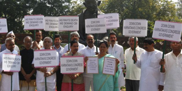 NEW DELHI, INDIA - MARCH 19: MPs from Karnataka protesting and demanding CBI probe on DK Ravi's death case at Parliament house on March 19, 2015 in New Delhi, India. Opposition forced deferment of consideration of the contentious Mines and Minerals Bill in Rajya Sabha till tomorrow, arguing that mineral-bearing states had not been consulted. (Photo by Arvind Yadav/Hindustan Times via Getty Images)