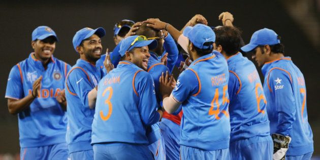 Indian players celebrate the dismissal of Bangladeshâs Mahmudullah during their Cricket World Cup quarterfinal match in Melbourne, Australia, Thursday, March 19, 2015. (AP Photo/Rick Rycroft)