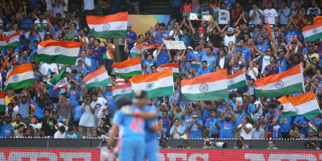 MELBOURNE, AUSTRALIA - MARCH 19: Fans celebrate as Suresh Raina of India celebrates making 50 runs during the 2015 ICC Cricket World Cup Quater Final match between India and Bangldesh at Melbourne Cricket Ground on March 19, 2015 in Melbourne, Australia. (Photo by Quinn Rooney/Getty Images)
