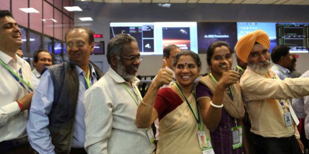 Indian Space Research Organisation scientists and officials cheer as they celebrate the success of Mars Orbiter Mission at their Telemetry, Tracking and Command Network complex in Bangalore, India, Wednesday, Sept. 24, 2014. India triumphed in its first interplanetary mission, placing a satellite into orbit around Mars on Wednesday morning and catapulting the country into an elite club of deep-space explorers. (AP Photo/Aijaz Rahi)