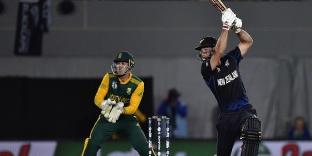New Zealand batsman Grant Elliott (R) while South African wicketkeeper Quinton de Kock looks on during the Cricket World Cup semi-final match between New Zealand and South Africa at Eden Park in Auckland on March 24, 2015. AFP PHOTO / MARTY MELVILLE (Photo credit should read Marty Melville/AFP/Getty Images)