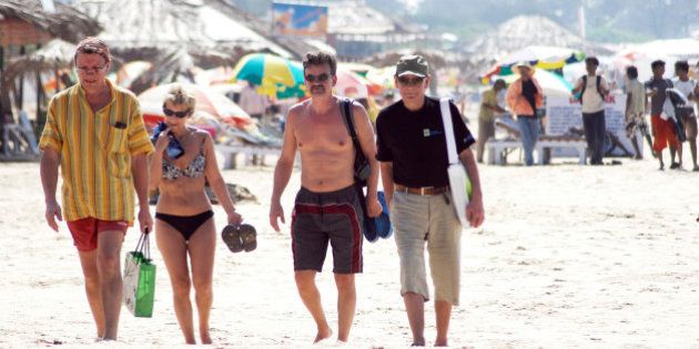In this Dec. 16, 2008 photo, tourists walk on the beach in Goa, India. With the country on alert in the wake of the terror attacks in Mumbai that killed 164 people and nine accused gunmen, Goa officials have banned beach parties and stepped up patrols. Scores of spooked foreigners have canceled vacations. (AP Photo)