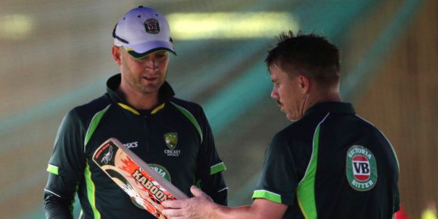 Australia's captain Michael Clarke, left, chats with David Warner after batting practice for the Cricket World Cup in Sydney, Australia, Wednesday, March 25, 2015. Australia will play India in a World Cup semifinal on Thursday to gain a place in the final against New Zealand.(AP Photo/Rob Griffith)