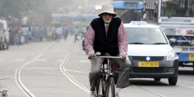 KOLKATA, INDIA - NOVEMBER 6: Bollywood actor Amitabh Bachchan rides a bicycle during shooting for his upcoming film Piku on the roads of Shyambazar on November 6, 2014 in Kolkata, India. (Photo by Subhankar Chakraborty/ Hindustan Times via Getty Images)