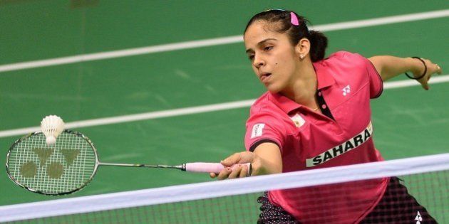 In this photograph taken on March 25, 2015, Saina Nehwal of India plays a shot during her women's badminton singles match against Riay Mukherjee of India at the Yonex-Sunrise India Open 2015 at the Siri Fort Sports Complex in New Delhi. Badminton star Saina Nehwal has shrugged off mounting pressure over whether she will become the first Indian woman ever to clinch the world number one ranking, at the Indian Open in New Delhi. Nehwal, currently number two after reaching the prestigious All-England Championship final this month, is expected to snatch the number one spot if she wins the tournament in front of a home crowd. AFP PHOTO / SAJJAD HUSSAIN (Photo credit should read SAJJAD HUSSAIN/AFP/Getty Images)
