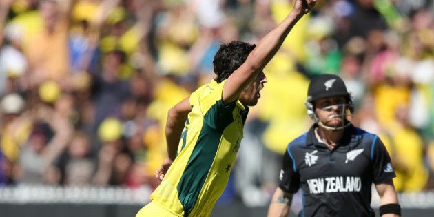 Australia's Mitchell Starc, left, celebrates after taking the wicket of New Zealand captain Brendon McCullum for no score during the Cricket World Cup final in Melbourne, Australia, Sunday, March 29, 2015. (AP Photo/Rick Rycroft)