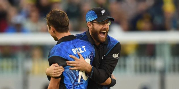 New Zealandâs Ross Taylor hugs teammate Trent Boult for the dismissal of Australia's Aaron Finch during the ICC Cricket World Cup final in Melbourne, Australia, Sunday, March 29, 2015. (AP Photo/Andy Brownbill)