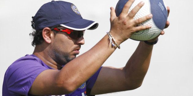 India's Yuvraj Singh holds a ball during a practice session in Ahmadabad, India, Tueday, Nov. 13, 2012. India and England are scheduled to play four cricket tests with the first test beginning on Nov. 15 in Ahmedabad. (AP Photo/Ajit Solanki)
