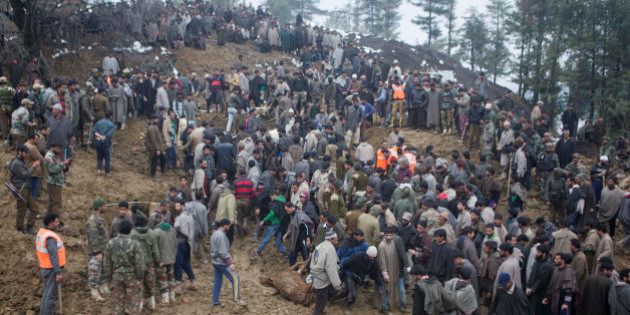 Kashmiri villagers and officials search for bodies of victims following landslides due to heavy rainfall in the village of Laden some 45 Kilometers (28 miles) west of Srinagar, Indian-controlled Kashmir, Monday, March 30, 2015. Hundreds of Kashmiris in both India and Pakistan moved to higher ground Monday as rain-swollen rivers swamped parts of the disputed Himalayan region placed under an emergency flood alert just six months after some 600 people died in flooding that left the region in shambles. (AP Photo/Dar Yasin)