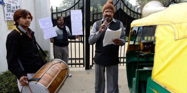 NEW DELHI, INDIA - JANUARY 02: MCD drum beaters outside the home of a tax defaulter in Sainik Farms on Wednesday. (Photo by K Asif/India Today Group/Getty Images)