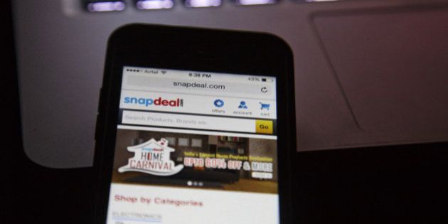 The Snapdeal.com website is displayed on an Apple Inc. Iphone in an arranged photograph in New Delhi, India, on Thursday, Aug. 21, 2014. India doesnt allow foreign-controlled companies to sell products online. Thats led local web retailers such as the local Snapdeal to a different model than the one pioneered by Amazon: they operate online marketplaces and local traders sell goods in a $3 billion e-commerce market. Photographer: Kuni Takahashi/Bloomberg via Getty Images