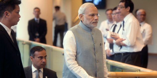 India's Prime Minister Narendra Modi, center, arrives at the state funeral for the late Lee Kuan Yew, at the University Cultural Center, Sunday, March 29, 2015 in Singapore. During a week of national mourning that began Monday after Lee's death at age 91, some 450,000 people queued for hours for a glimpse of Lee's coffin at Parliament House. A million people visited tribute sites at community centers across the island and leaders and dignitaries from more than two dozen countries attended the state funeral. (AP Photo/Joseph Nair)