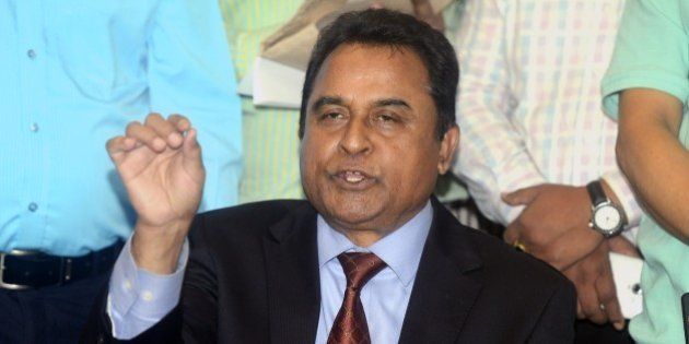 Mustafa Kamal (C), former president of the International Cricket Council, speaks to the media in Dhaka on April 1, 2015. Kamal resigned April 1 as president of the International Cricket Council, accusing colleagues within the game's global body of acting 'unlawfully'. AFP PHOTO (Photo credit should read STR/AFP/Getty Images)