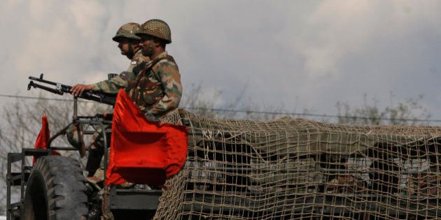 Indian army soldiers take position on a truck during an attack by suspected Kashmiri rebels near an army camp in Samba, about 48 kilometers south of Jammu, India, Saturday, March 21, 2015. Indian soldiers killed two suspected Kashmiri rebels Saturday after they tried to sneak into the army's main infantry headquarters in the Indian portion of the disputed Himalayan territory, police said. (AP Photo/Channi Anand)
