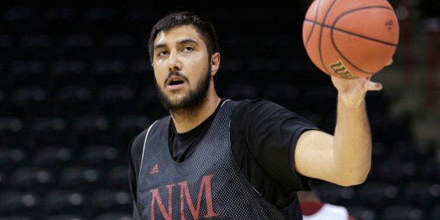New Mexico State's Sim Bhullar reaches for a ball during practice for the NCAA college basketball tournament in Spokane, Wash., Wednesday, March 19, 2014. New Mexico State plays against San Diego State in a second-round game on Thursday. (AP Photo/Elaine Thompson)