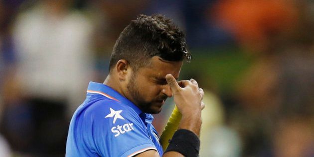 Indian batsman Suresh Raina reacts as he leaves the field after he was dismissed for 22 runs during their Cricket World Cup Pool B match against the West Indies in Perth, Australia, Friday, March 6, 2015. (AP Photo/Theron Kirkman)