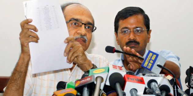 Prashant Bhushan, left, and Arvind Kejriwal, associates of Anna Hazare, India's most prominent anti-corruption activist, display a list of 15 ministers serving in the present government, including its leader and Prime Minister Manmohan Singh, against whom they have prepared evidences of corruption, at a press conference in New Delhi, India, Saturday, May 26, 2012. Files containing evidences of corruption have been sent to Singh, asking him to constitute an investigation team of eminent judges to verify their claims. (AP Photo/Saurabh Das)