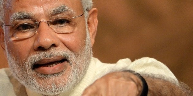 Indian Prime Minister Narendra Modi gestures as he speaks during the inauguration of a conference on Financial Inclusion in Mumbai on April 2, 2015. The conference was organised on the occasion of completion of 80 years of the Reserve Bank of India (RBI). AFP PHOTO/PUNIT PARANJPE (Photo credit should read PUNIT PARANJPE/AFP/Getty Images)