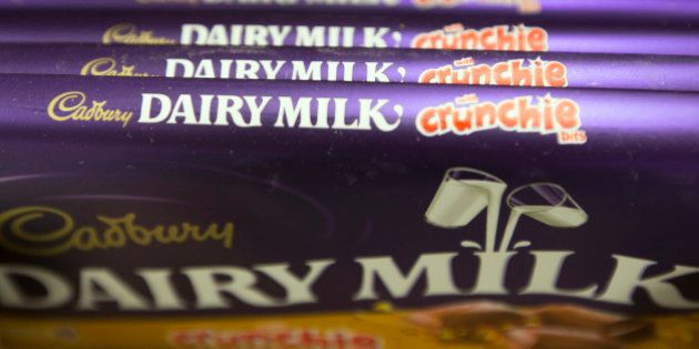 Bars of Cadbury 'Dairy Milk Crunchie' chocolate, manufactured by Kraft Foods Inc., sit displayed for sale inside an Asda supermarket, the U.K. retail arm of Wal-Mart Stores Inc., in Watford, U.K., on Thursday, Oct. 17, 2013. U.K. retail sales rose more than economists forecast in September as an increase in furniture demand led a rebound from a slump the previous month. Photographer: Simon Dawson/Bloomberg via Getty Images