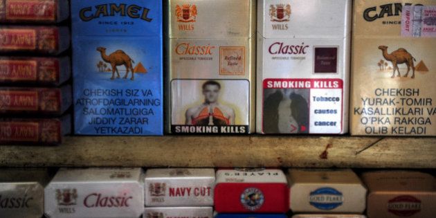 A packet of cigarettes (C), adorned with an image said to resemble that of Chelsea and England footballer John Terry, stands on a stall in New Delhi on January 3, 2012. Representatives of Chelsea captain John Terry have lodged a complaint over the apparent use of his image for a tobacco warning printed on cigarette packets in India, a report said. The blurry image that features the head and shoulders of a man resembling Terry above a warning that 'Smoking Kills' was created by the government agency the Directorate of Visual Publicity, the Indian Express reported. AFP PHOTO/Findlay KEMBER (Photo credit should read FINDLAY KEMBER/AFP/Getty Images)