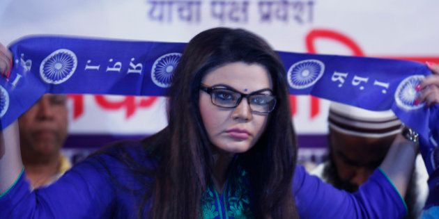 MUMBAI, INDIA - JUNE 28: Bollywood actor turned poltician Rakhi Sawant after she joined Republican Party of India (RPI) in the presence of party Chief Ramdas Athavale at MIG Club on June 28, 2014 in Mumbai, India. She was made the national executive president of RPI womens wing. Just before the 2014 Lok Sabha elections, Sawant supported the BJP and Narendra Modi. However, when the BJP overlooked her for a ticket, Sawant floated her own political party Rashtriya Aam Party and contested the polls from the Mumbai North-West constituency, securing just 1,995 votes. (Photo by Satish Bate/Hindustan Times via Getty Images)