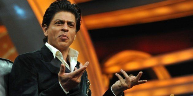 Indian Bollywood actor Shah Rukh Khan gestures during a press interaction to launch a new television show India Poochega Sabse Shaana Kaun? in Mumbai on February 24, 2015. AFP PHOTO/STR (Photo credit should read STRDEL/AFP/Getty Images)