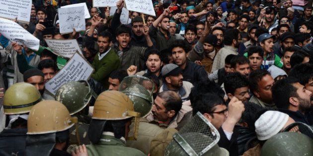 Supporters of the Jammu and Kashmir Libration Front (JKLF) shout anti-Indian slogans during a protest against the treatment of Kashmiri students from a university in Srinagar on March 7, 2014. Police in northern India said they had dropped sedition charges against a group of Kashmiri students who cheered on Pakistan in a recent cricket match, but they could still face prosecution over the incident. A group of 60 students were suspended from the Swami Vivekanand Subharti University (SVSU) in the town of Meerut and escorted from the campus over what the vice chancellor called 'unacceptable' behaviour after the match. AFP PHOTO/Tauseef MUSTAFA (Photo credit should read TAUSEEF MUSTAFA/AFP/Getty Images)