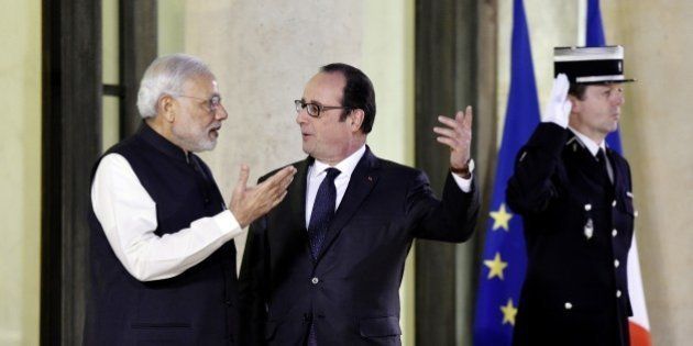 French President Francois Hollande (C) welcomes Indian Prime Minister Narendra Modi (L) upon his arrival for an official dinner at the Elysee palace in Paris on April 10, 2015, as part of Modi's official visit in France. India's prime minister announced that New Delhi had ordered 36 Rafale fighter jets from France in a multi-billion-euro agreement that has been years in the making. Standing alongside his counterpart Francois Hollande on a visit to France -- the first leg of his maiden trip to Europe -- Narendra Modi finally relieved the frantic speculation over whether tortuous, years-long negotiations on buying the jets would ever bear fruit. AFP PHOTO/ ALAIN JOCARD (Photo credit should read ALAIN JOCARD/AFP/Getty Images)