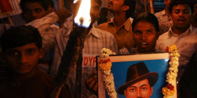 Members of Democratic Youth Federation of India and Students Federation of India hold a photograph of Bhagat Singh as they participate in a torch rally to pay tribute to Indian freedom fighters Bhagat Singh, Sukhdev and Rajguru who were hanged to death by the British on March 23, 1931, in Hyderabad, India, Monday, March 23, 2009. (AP Photo/Mahesh Kumar A)